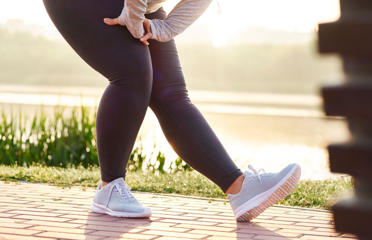 Woman performing self-heel stretches before a workout